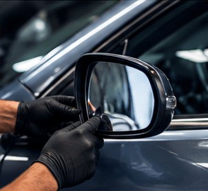 Vehicle side mirror being repaired