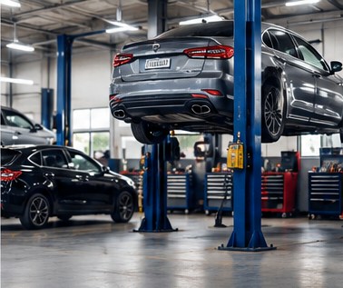 Car raised on a lift in a clean auto repair service bay